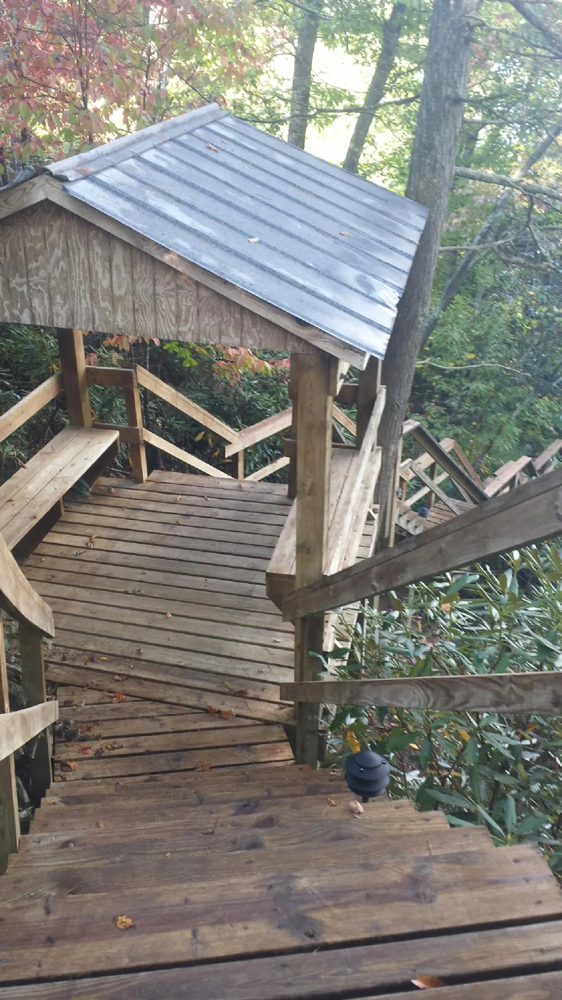 Metal roofed shelter over wooden steps on a wooded walkway — Skylight Repair & Installation work by our crew in Ardara